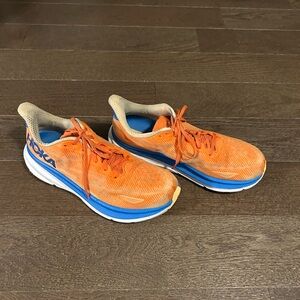 HOKA One One Clifton 9 shoe in the Vibrant Orange/Impala